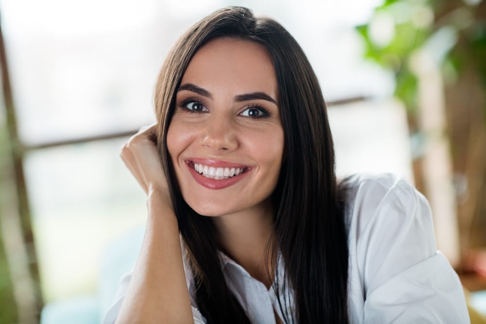 Woman smiling with bright white teeth after professional teeth whitening treatment in San Diego – Teeth Whitening San Diego